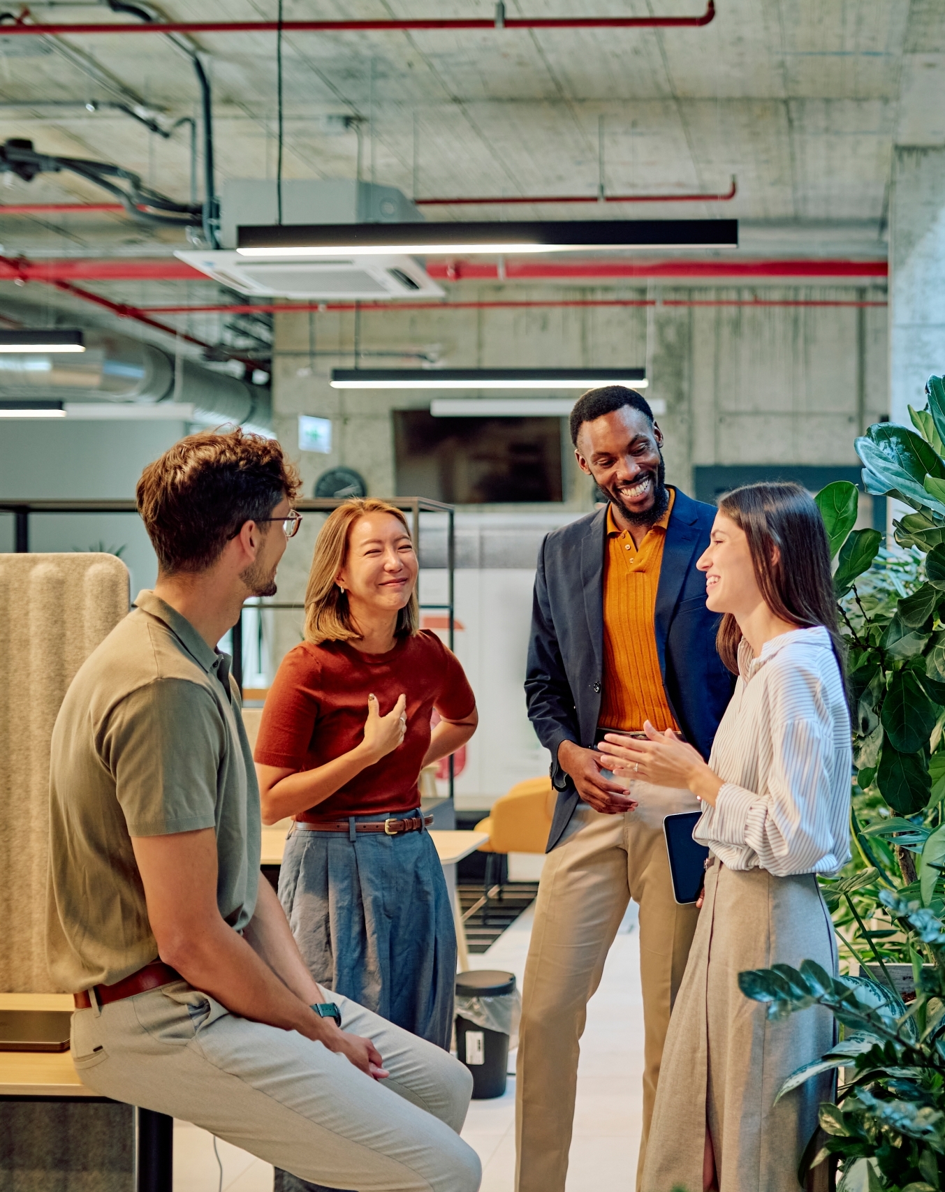 Business team discussing new project in modern office with plants